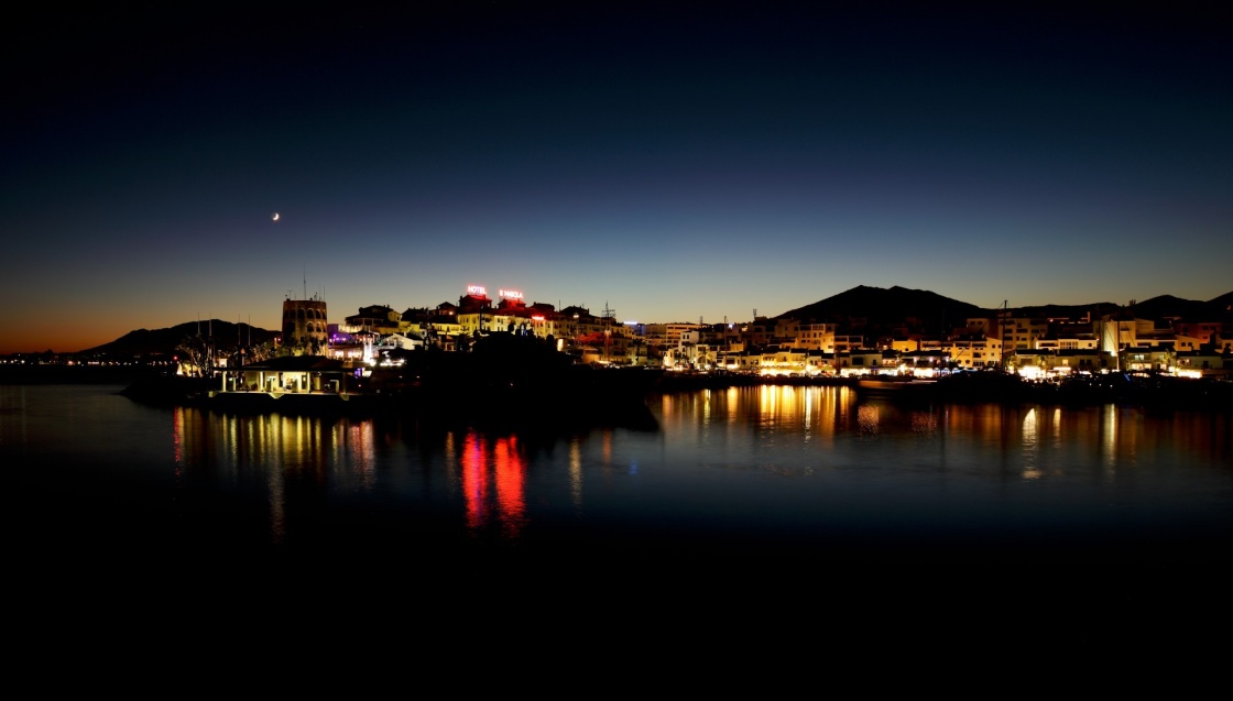 Puerto Banus in Marbella, Spain at night. Marbella is a popular holiday destination located on the Costa del Sol in the southern Andalusia, it lies beneath the Cordillera Penibetica mountains 